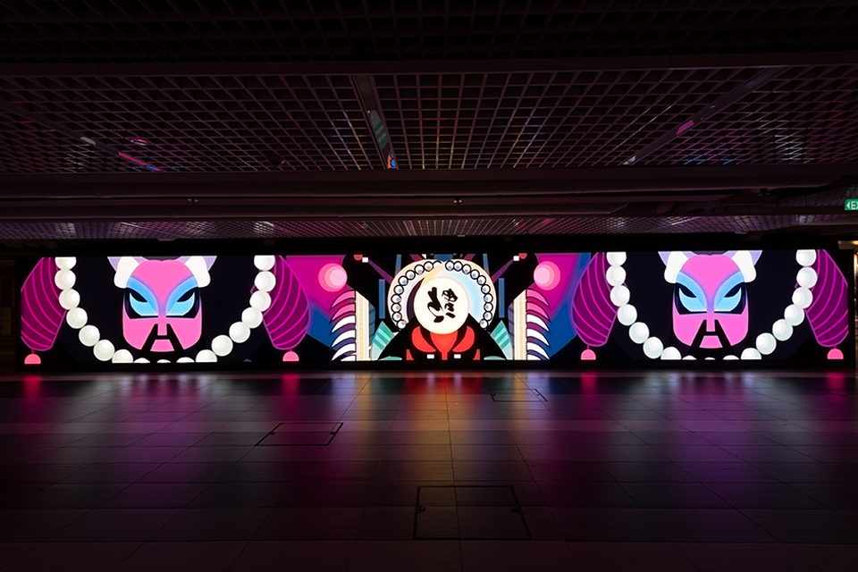 LED screen in a corridor displaying digital artwork.