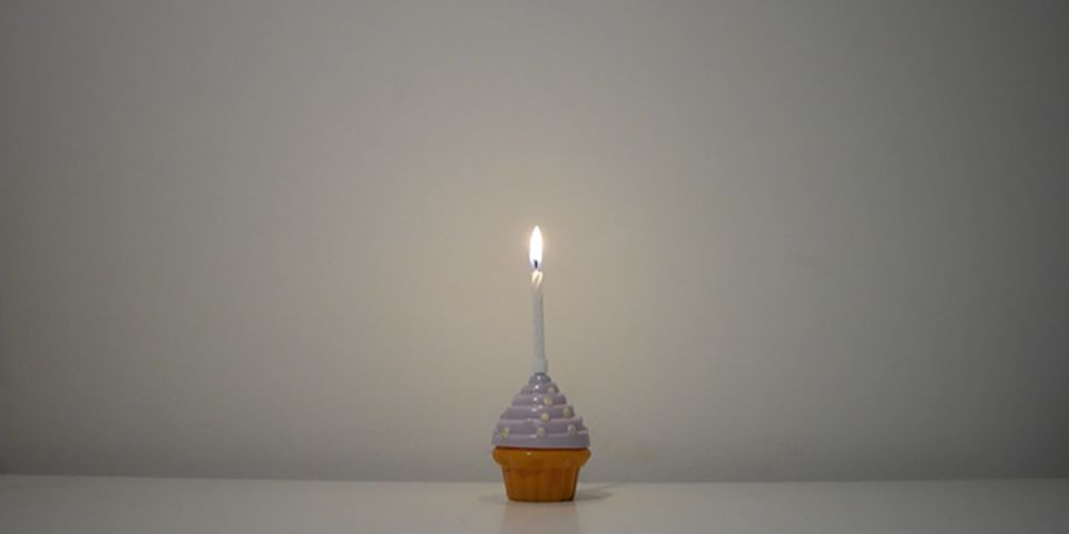 A cupcake with a candle in.